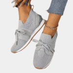 Stijlvolle grijze damessneakers met veters, gebreid patroon en witte zool. Perfect voor casual outfits. Comfortabele en trendy schoenen.